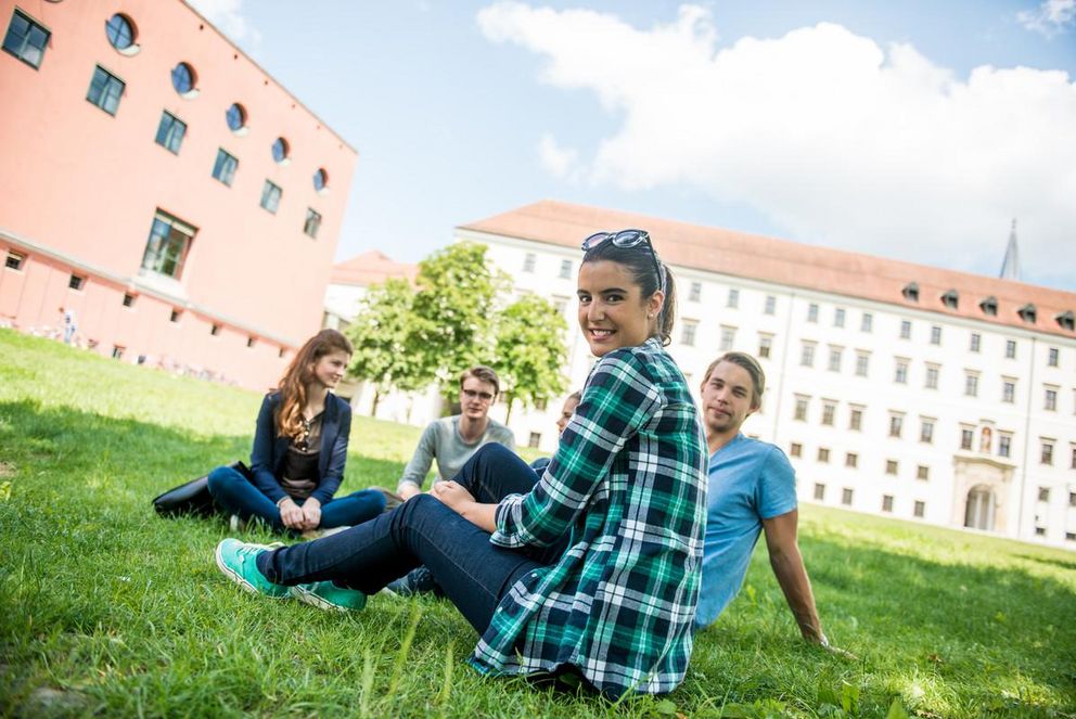 Students sitting on Innwiese meadow