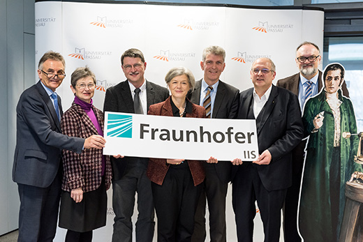 From left to right: Walter Taubeneder (Member of the Bavarian Parliament), Gerlinde Kaupa (Deputy District Administrator), Professor Tomas Sauer, Professor Carola Jungwirth (President of the University), Professor Gerhard Waschler (Member of the Bavarian Parliament), Professor Randolf Hanke, (Head of Fraunhofer Development Center X-Ray Technology) and J&uuml;rgen Dupper (Head Mayor of the City of Passau), with a cardboard cutout of Joseph von Fraunhofer, after whom the Fraunhofer Society is named. Photo: University of Passau